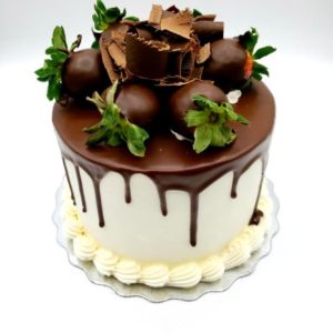 Strawberry Venetian Truffle Cake (vanilla cake, fresh berries & venetian cream filling, vanilla buttercream, hazelnut fudge ganache, garnished with chocolate dipped berries.