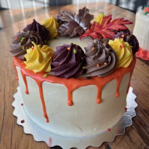 Fall Splendor Cake 9" (serves 6-8) Vanilla cake, vanilla buttercream icing, spiced cinnamon cream filling